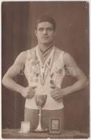 1941 Sportbajnok érmeivel és kupával, fotólap, hátoldalon feliratozva, 9x13 cm