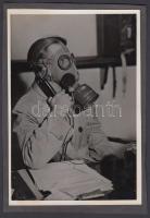 cca 1940-1944 Telefonálás gázálarcban, kartonra ragasztott fénykép, 17x12 cm