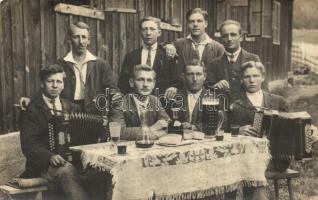 Men with accordionists at a beer garden, group photo (EK)