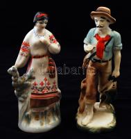 2 db figurális porcelán: nő népviseletben, kézzel festett, jelzett, apró kopásnyomokkal, m: 23,5 + Férfi halakkal, bisquit Arpo porcelán, kézzel festett, jelzett,apró kopásnyommal, m: 24 cm
